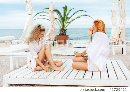 two beautiful girls drinking and have fun two beautiful girls drinking and have fun 41729411