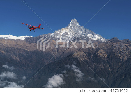Ultralight plane flies over Pokhara, Machapuchare Ultralight plane flies over Pokhara, Machapuchare 41731632