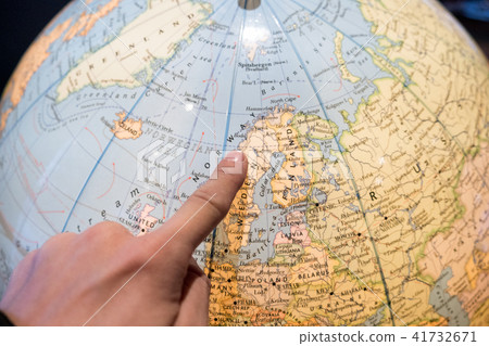 Finger pointing on world ball for planning Finger pointing on world ball for planning 41732671