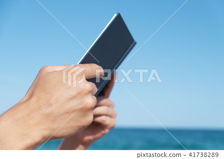 man reading a book on the beach man reading a book on the beach 41738289