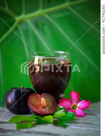 fresh plums juice on a white wooden background 41740265