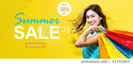 Summer sale with happy young woman holding shopping bags 41742685