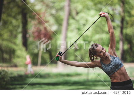 Slim lady is laughing while stretching Slim lady is laughing while stretching 41743015