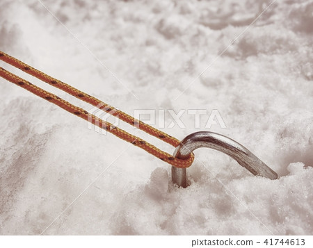 Chrome steel hook anchor camping tent in snow. Chrome steel hook anchor camping tent in snow. 41744613