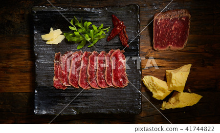 Barbecue wagyu roast beef sliced as top view on a metal tray with copy space right 41744822