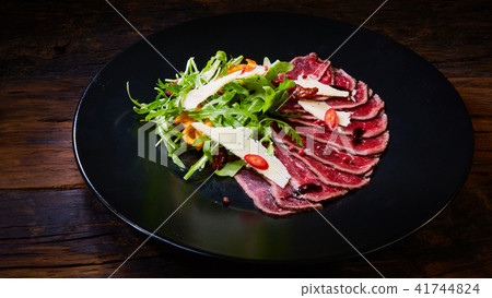 Barbecue wagyu roast beef sliced as top view on a metal tray with copy space right 41744824