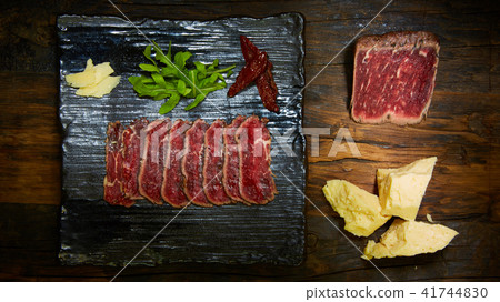 Barbecue wagyu roast beef sliced as top view on a metal tray with copy space right 41744830