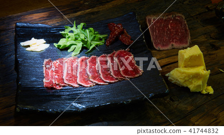 Barbecue wagyu roast beef sliced as top view on a metal tray with copy space right 41744832