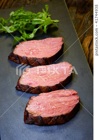 Sous-vide steak cut into pieces, cooked to eat beef on the stone table 41744938