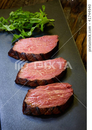 Sous-vide steak cut into pieces, cooked to eat beef on the stone table 41744940