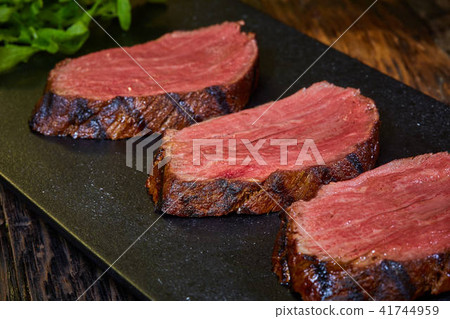 Sous-vide steak cut into pieces, cooked to eat beef on the stone table 41744959
