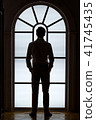 Silhouette of the groom on the window background. The concept of the morning groom 41745435