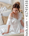 Charming girl in a luxurious bed with a bare shoulder 41745438