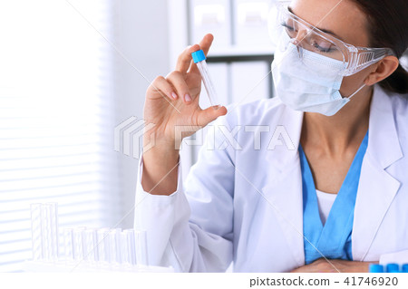 Female scientific research is looking at the tube in laboratory. Blood test concept 41746920
