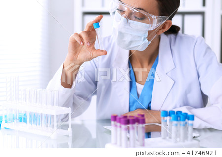 Female scientific research is looking at the tube in laboratory. Blood test concept 41746921