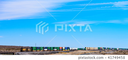 Long distance cargo train crossing the Americas wide panorama 41749458