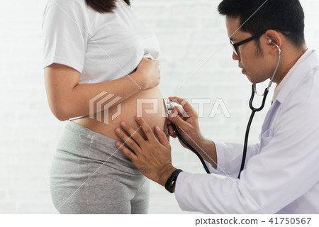 Doctor examining a pregnant woman Doctor examining a pregnant woman 41750567