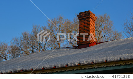 Brick chimney of old house with covered snow 41751258