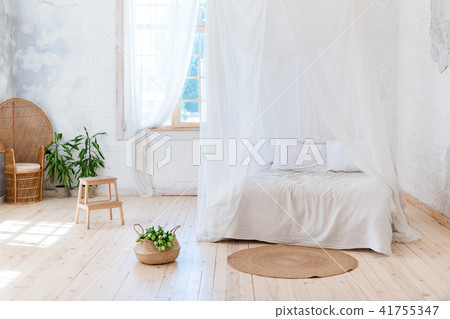 Cozy bedroom in light colors with a wooden floor 41755347