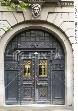 Ancient  gates on the facade of the building 41756449