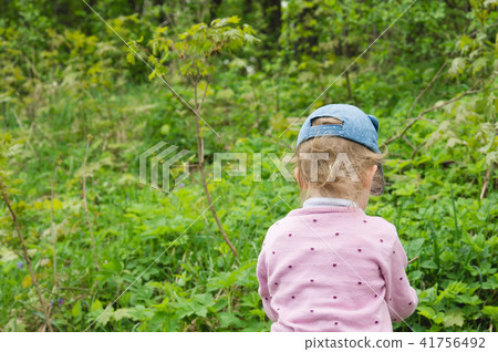 A blonde little girl, returning with back  41756492