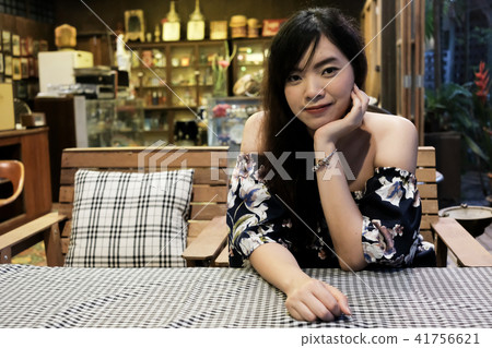 Close up of young Asian woman in the restaurant. Close up of young Asian woman in the restaurant. 41756621