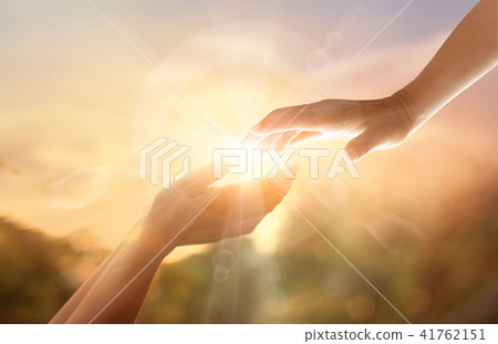 God's helping hand with white cross on sunset. God's helping hand with white cross on sunset. 41762151