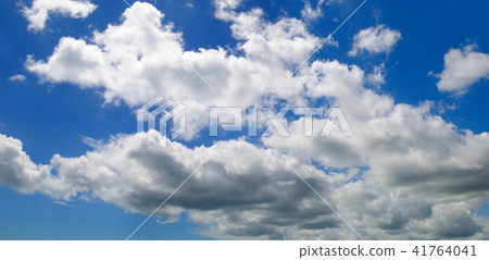 Cumulus clouds in the blue sky. Wide photo. 41764041