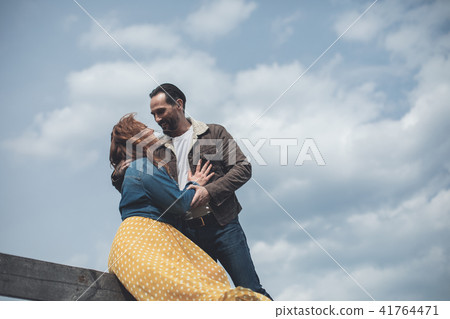 Mature loving couple embracing outdoor with tenderness Mature loving couple embracing outdoor with tenderness 41764471