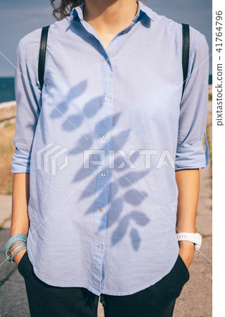 Young woman standing by the sea Young woman standing by the sea 41764796