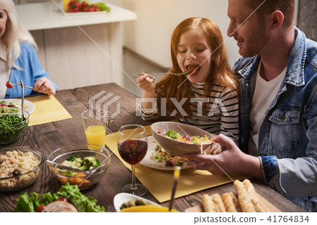 Happy father and daughter eating together 41764834
