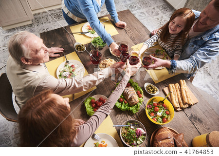 Happy family cheering together at home 41764853