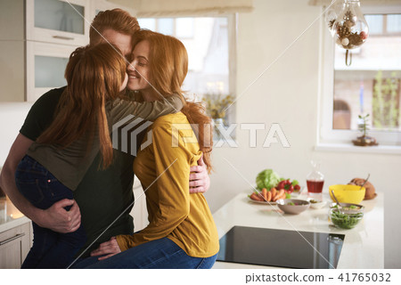 Loving mother and father in kitchen with child Loving mother and father in kitchen with child 41765032