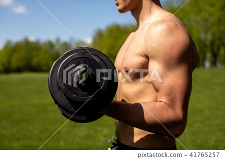 Strong man is exercising with sport equipment Strong man is exercising with sport equipment 41765257