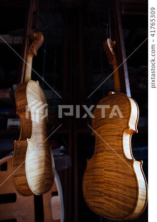 Closeup view of beautiful brown wooden string musical instrument of violin. 41765309