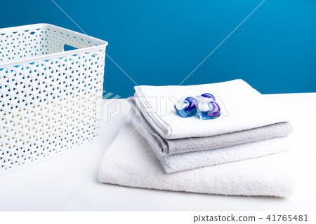 Heap of soft washed laundry with detergent on top Heap of soft washed laundry with detergent on top 41765481
