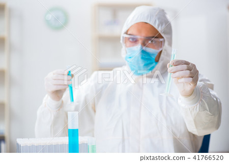 Young chemist student working in lab on chemicals 41766520