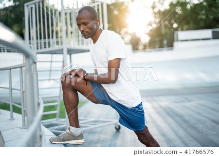 Glad male making workout on stadium 41766576