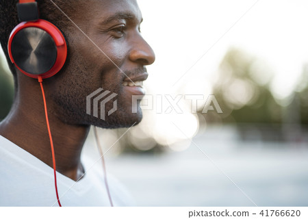 Positive adult male listening music in headsets 41766620