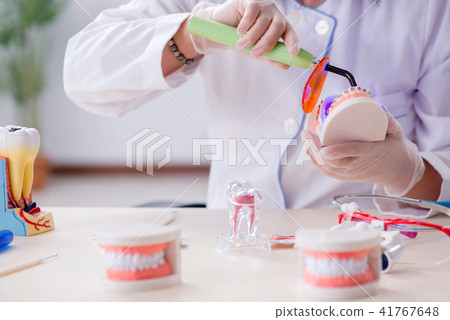 Woman dentist working on teeth implant Woman dentist working on teeth implant 41767648