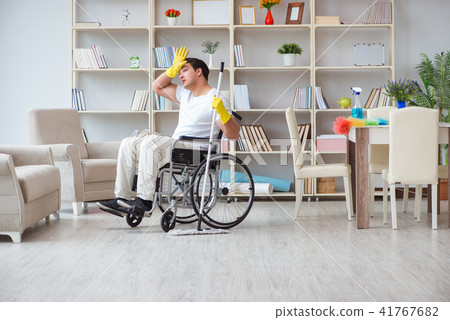 Disabled man cleaning floor at home 41767682