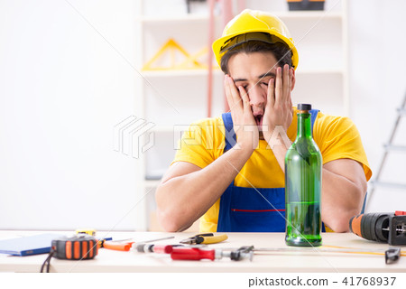 Drunk engineer working in the workshop 41768937