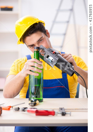 Drunk engineer working in the workshop Drunk engineer working in the workshop 41768955