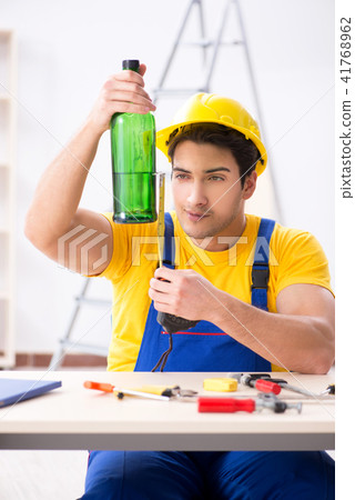 Drunk engineer working in the workshop Drunk engineer working in the workshop 41768962