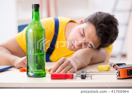 Drunk engineer working in the workshop Drunk engineer working in the workshop 41768964