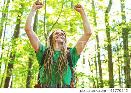 Happy hiker raising his hands in the air 41770345