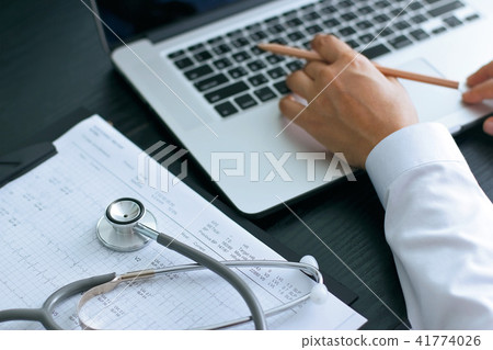 Doctor using laptop working on the desk Doctor using laptop working on the desk 41774026