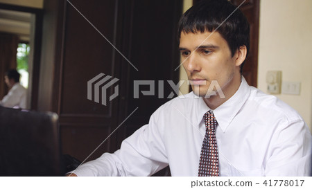 Handsome businessman working on an office. Young man typing on a laptop 41778017