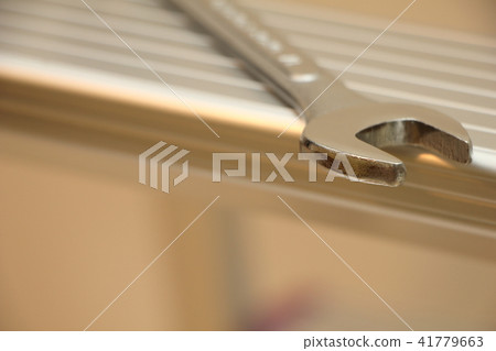 A spanner placed on a stepladder A spanner placed on a stepladder 41779663