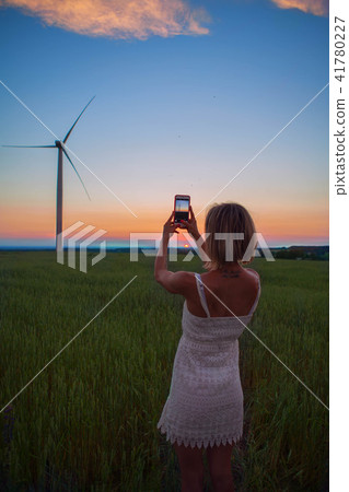 The girl taking a photo of the windmill 41780227